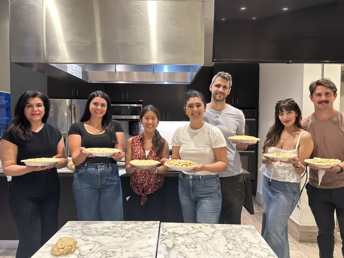 Image of adult students holding pies that they've baked.